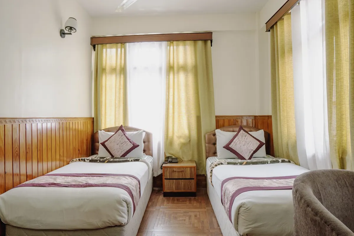 Twin beds in a Standard Room at Hotel Tibet Gangtok