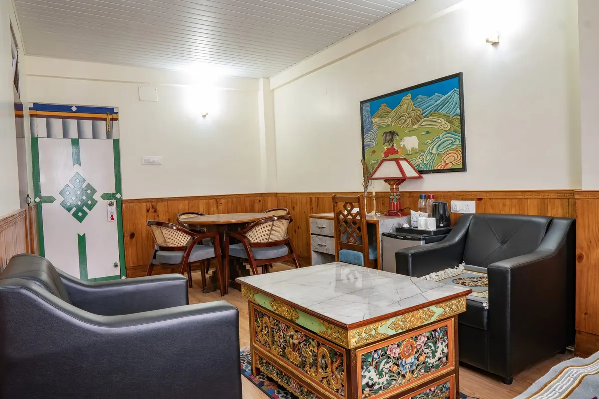 A suite sitting area at Hotel Tibet Gangtok, with a painted Tibetan table
